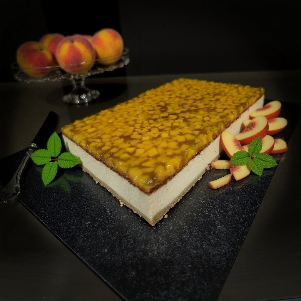 Cheesecake created right at the bakery covered with fresh peaches in jelly