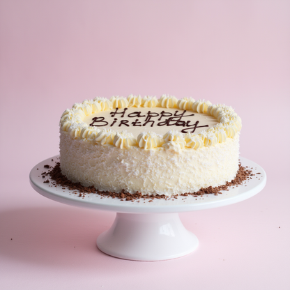 White birthday cake with 'Happy Birthday' on a pink background

