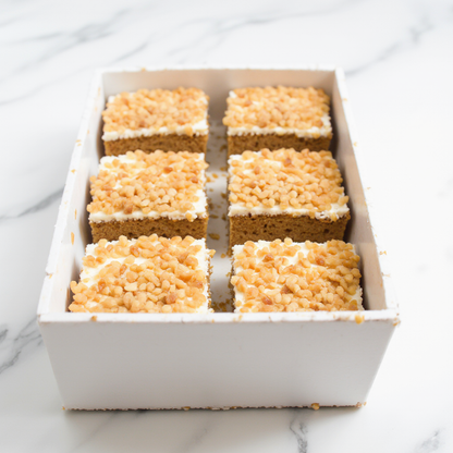 Box of six square dessert bars on a marble surface