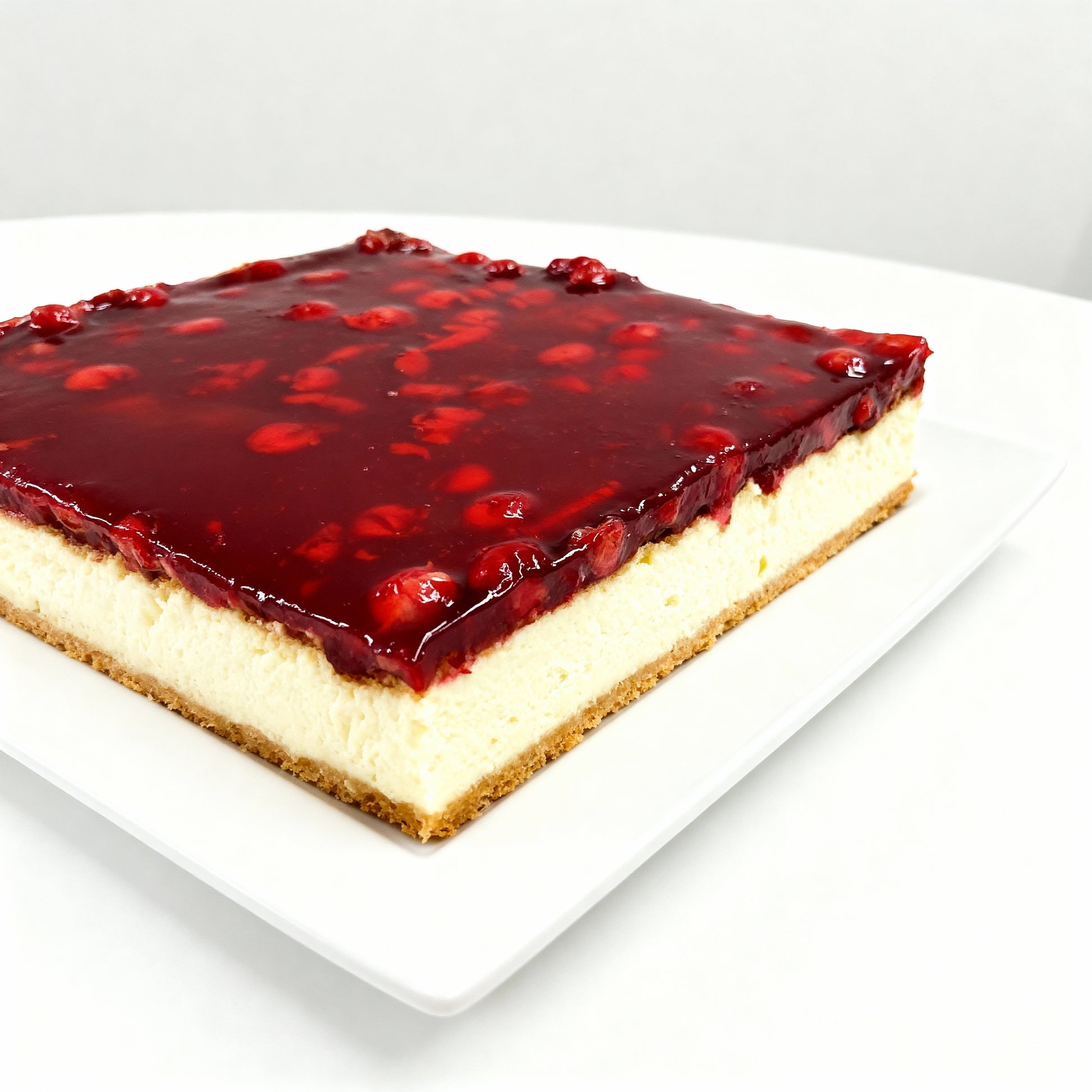 Freshly baked cheesecake covered with cherries in jelly from the Happy Family Bakery
